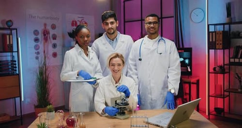 Smiling Scientists Pose in a Modern Laboratory
