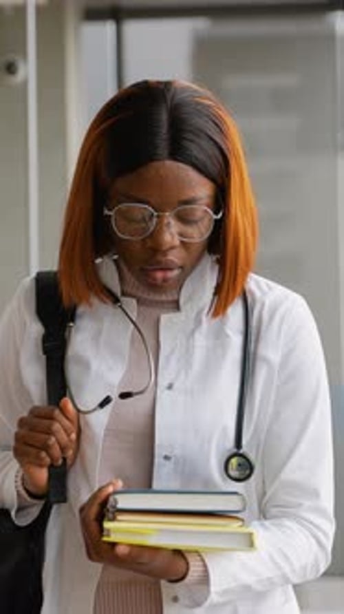 African American Medical Intern Walking in College Hallway