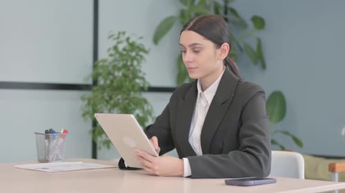 Woman Using Tablet in Modern Office Environment