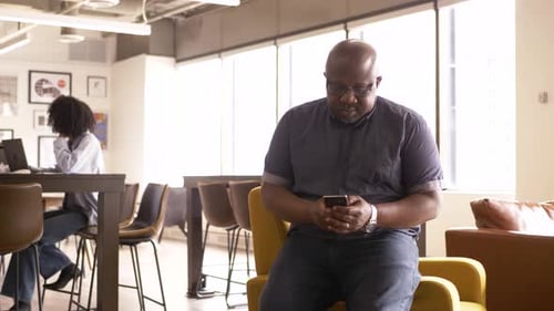 Businessman Using Smart Phone in Office 5054 Years