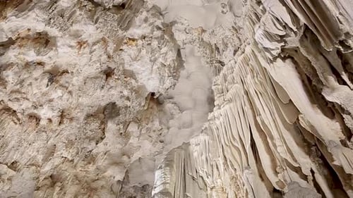 Cave limestone underground with white stalactites and stalagmites. Giant natural cavern amazing worl
