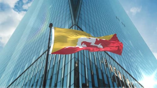Bhutan Flag Waving in Front of Modern Skyscraper