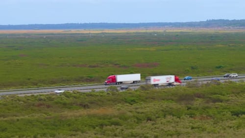 Heavyduty Big Rig Hauling Goods Across American Freeway Corridor High Speed Freeway Transportation