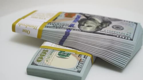 Stack of Bank Bundles with US Dollars on a White Background Closeup Shot of New Freshly Printed