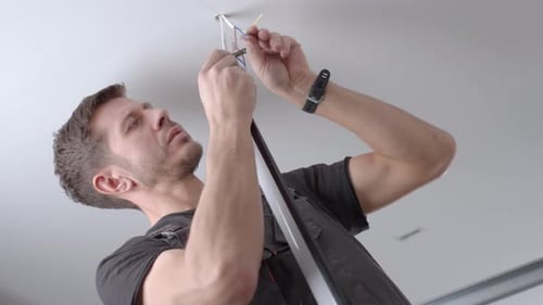 Man Working on Electrical Wiring in Residential Building