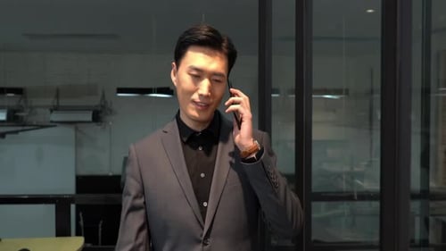 Young Man Talking on Phone in Modern Office
