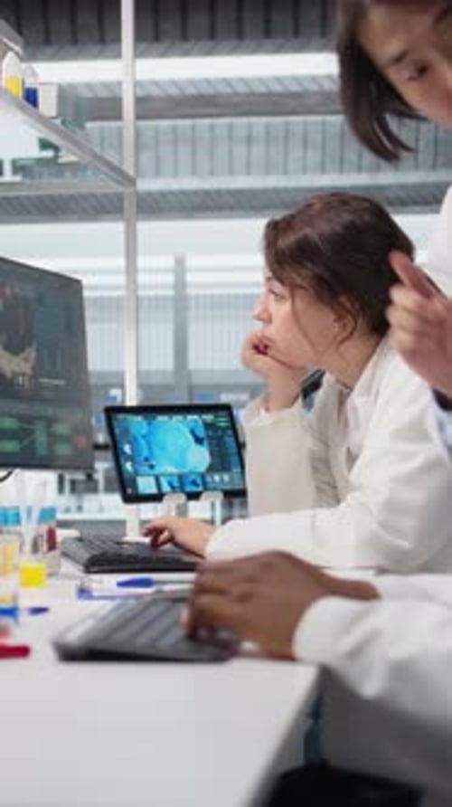 Vertical Video Diagnostic Laboratory Manager Overseeing Scientists Looking at Molecular Models
