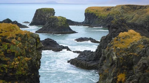 Ocean Waves Crashing on Black Volcanic Cliff Pure Blue Sea Coastline in Iceland