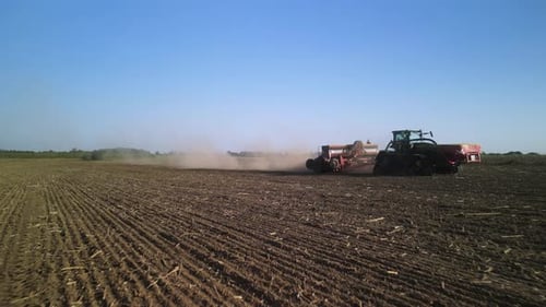 Tractor on the field seeding wheat