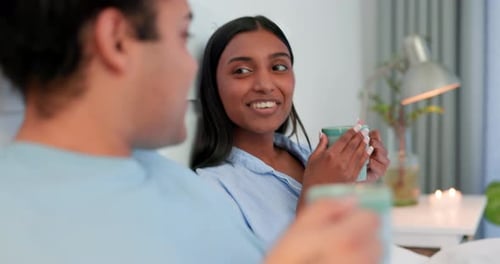 Happy Couple Relaxing and Chatting in Bed