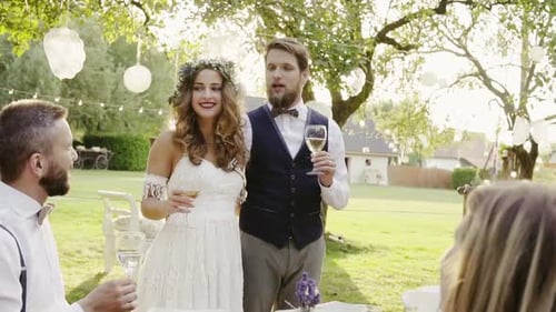 Newlyweds Toasting with Friends at Wedding Reception
