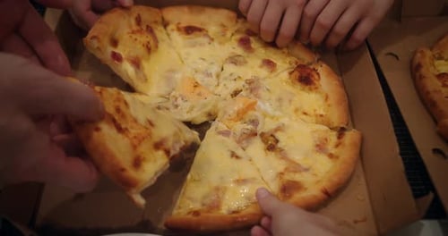 Close up Hands Taking Slices of Cheese Pizza