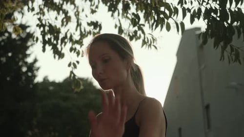 Woman Performs Dance Moves at Sunset
