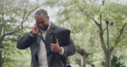 Man Celebrates Good News on Phone in Park