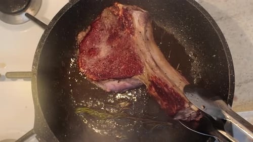 Ribeye Steak Cooking with Butter, Garlic, and Rosemary