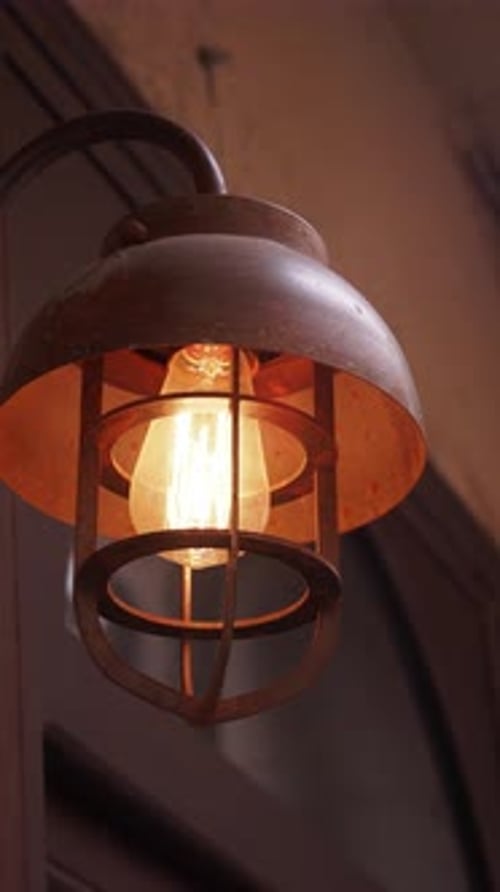 Rustic Metal Lantern Illuminates Cozy Interior Space