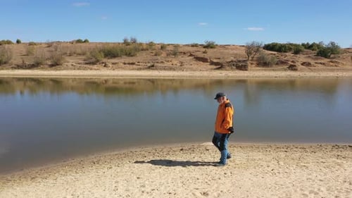 Photographer Man Walking By The Lake