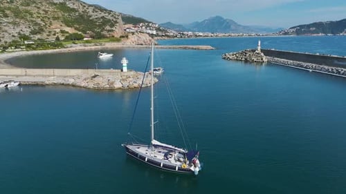 Minimalist Elegance of a Single Yacht Approaching the Marina Surrounded By Orderly Docked Vessels