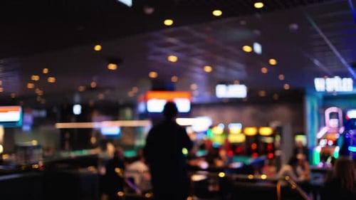 An Exciting and Vibrant Casino Atmosphere Filled with Dazzling Neon Lights and Various Game Machines