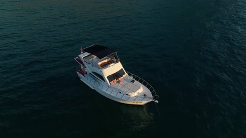 Aerial Drone Tracking Top Down Video of Yacht Cruising in Deep Blue Open Ocean Sea