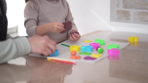 Child and Adult Play With Colorful Clay Indoors