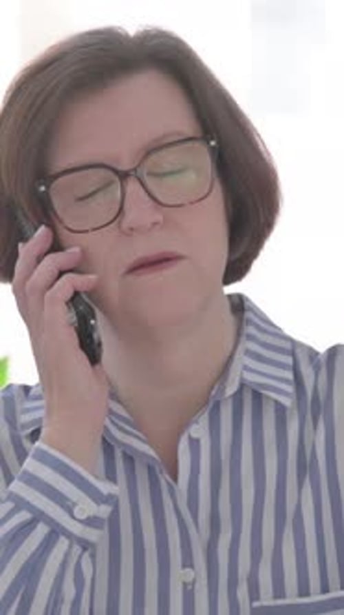 Senior Woman Talking on Phone, Discussing Work, Vertical Video