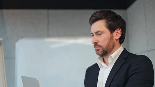 Focused Business Professional Pondering in Office Setting