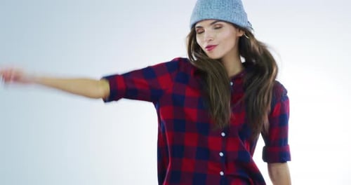 Stylish Woman in Hat Dancing Against White Background