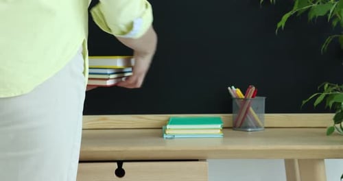 Stacking Colorful Books on Desk with Apple