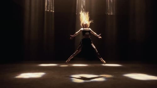 Contemporary Dance By A Girl In Black In A Spotlit Studio