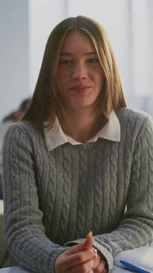 Teenage Girl Smiling in Classroom Wearing Braces