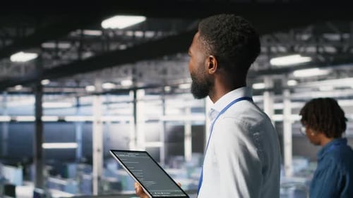 Data Center Programmer Checking Lines of Code Next to Colleague