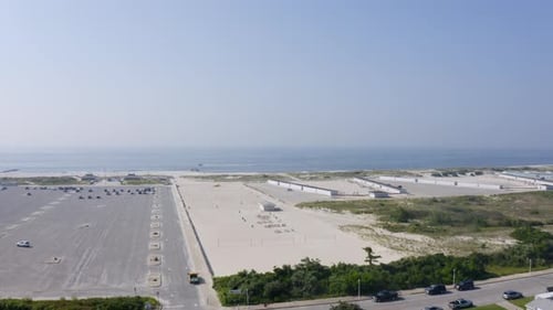 Aerial rise of the parking area along the shore of Long Beach in Long Island