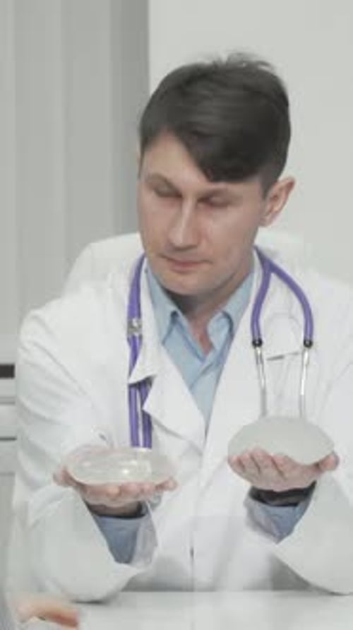 Plastic Surgeon Presenting Silicone Breast Implant Options to a Patient