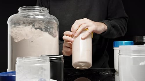 Athlete shaking the Protein Powder and milk mixture, preparing a smooth shake for muscle recovery
