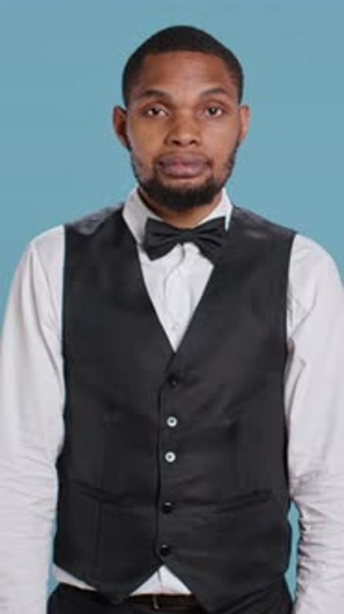 Vertical Video Portrait of Bellhop Hotel Employee Posing with Arms Crossed