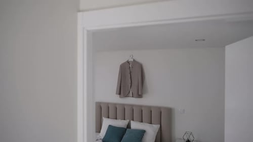 Modern Bedroom with Bed, Pillows, and Jacket