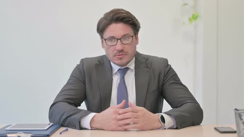 Frustrted Angry Middle Aged Businessman Sitting in Office, Tense