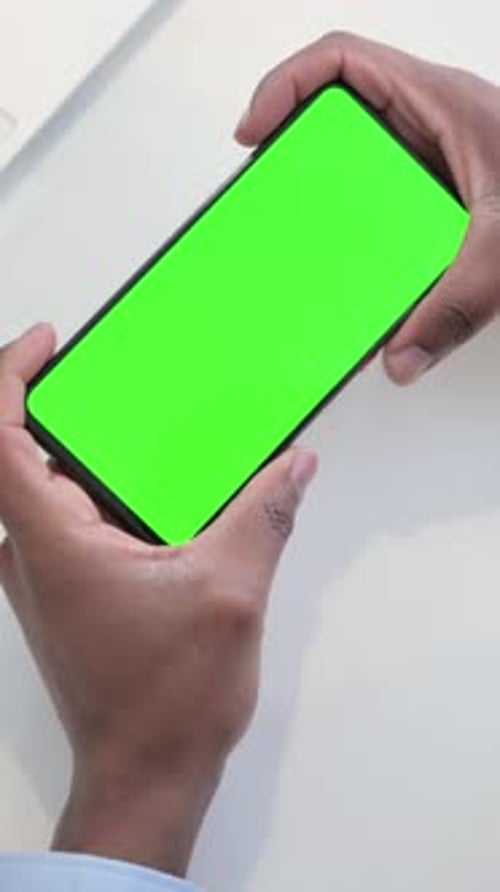 Businessman using Smartphone with Green Chroma Key Screen, Vertical Video