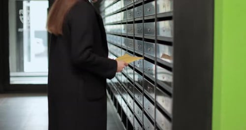 Woman Inserting Letter in Mailbox Mail Delivery Mail Shipping Concept