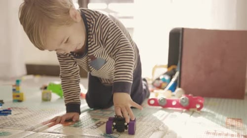Little Boy Playing with Toys on the Floor