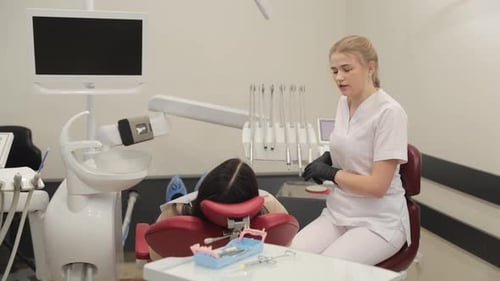 A Highly Skilled Dental Professional Assists a Patient in a Modern and Stateoftheart Dental Office