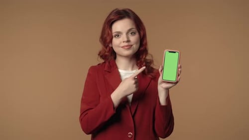 Woman Presenting Phone with Green Screen Technology