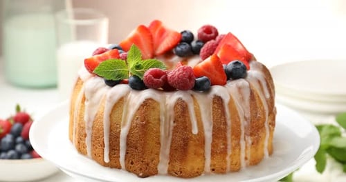 Hand Decorating Ring Cake with Berries and Mint