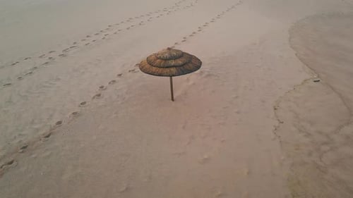 Lonely Straw Umbrella Empty Beach Aerial View Beige Sandy Surface Footprints