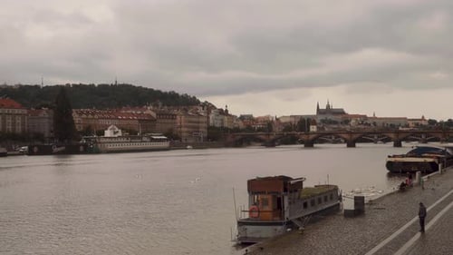 View of Vltva river in Prague on a cloudy day, pan