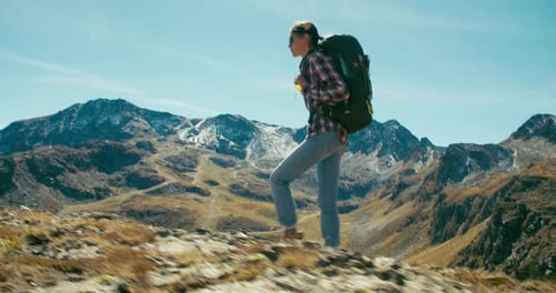 Woman with Hike Backpack Walk on Mountain Top on Tourist Path at Vacation Trip
