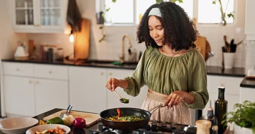 Woman Cooks and Tastes Vegetables in Kitchen