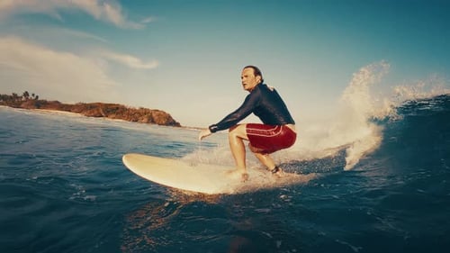 Surfer Rides the Ocean Wave in the Maldives In Water and Underwater View of the Surfer on the Wave