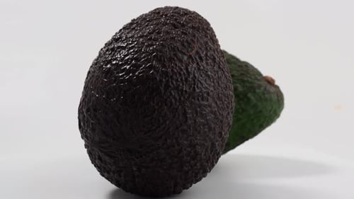 Two Avocados on a White Surface